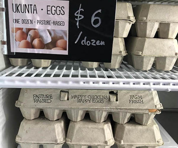 Cartons of Liberation Farms eggs in a store refrigerator