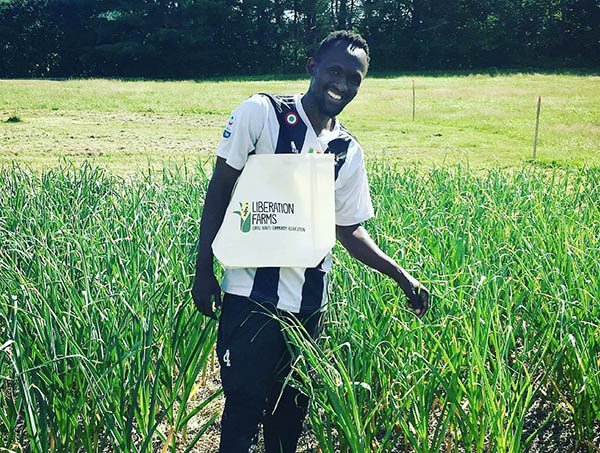 A Somali Bantu Farmer with a Liberation Farms tote bag