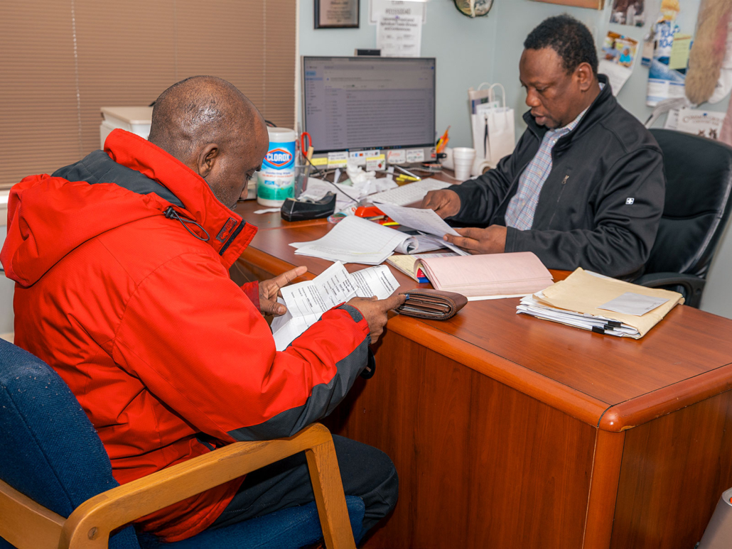 Client Navigation worker helps Somali Bantu immigrant review important documents
