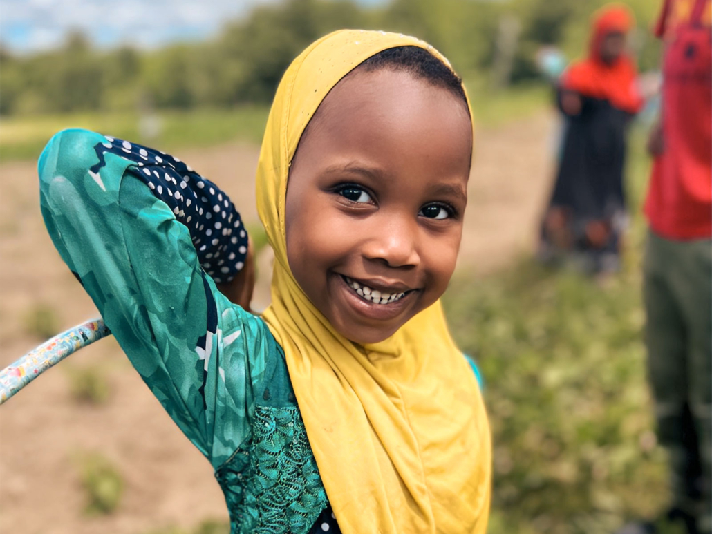 Smiling Somali Bantu girl enjoys sunny day