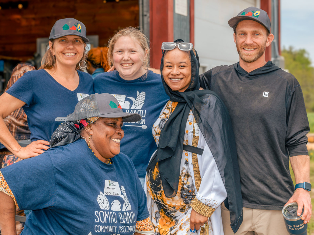 omali Bantu Community Association staff smiling together at outdoor event