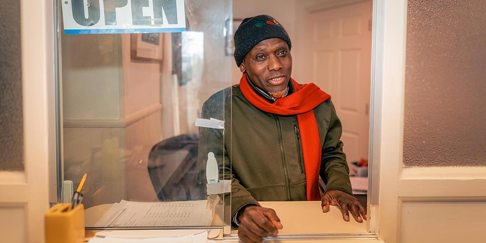 Client Navigation Services staff welcomes visitors behind open office service window